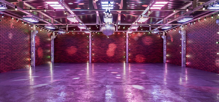 Retro venue space with disco ball and warm lighting