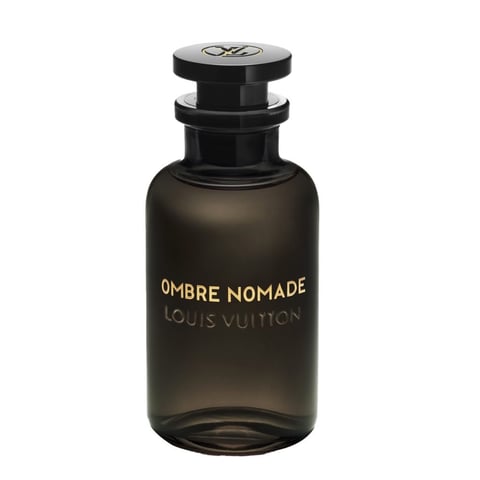 Amber Toned Perfume Bottle With A Gleaming Copper Cap On Soft Yellow Background